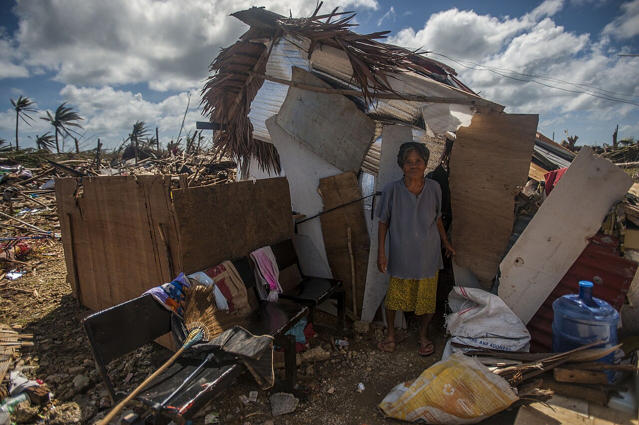 Archive photo from Guiuan, Eastern Samar: a resident stands beside a damaged home after Super Typhoon Haiyan in 2013.